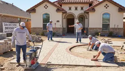 Technicians installing driveway pavers in San Antonio TX with precise leveling and base preparation